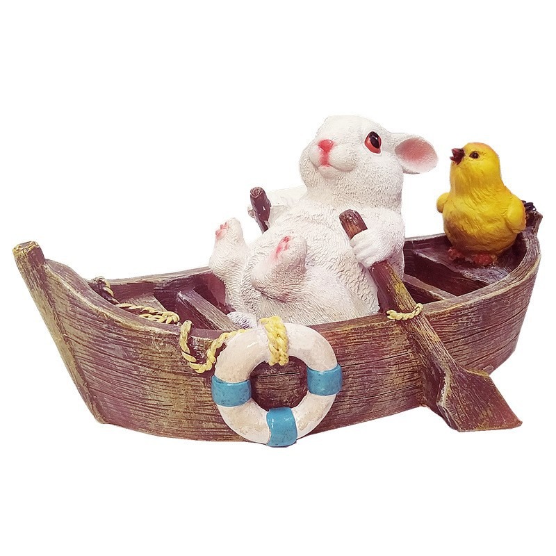A rowing rabbit resin ornament floating on the water surface — image 1