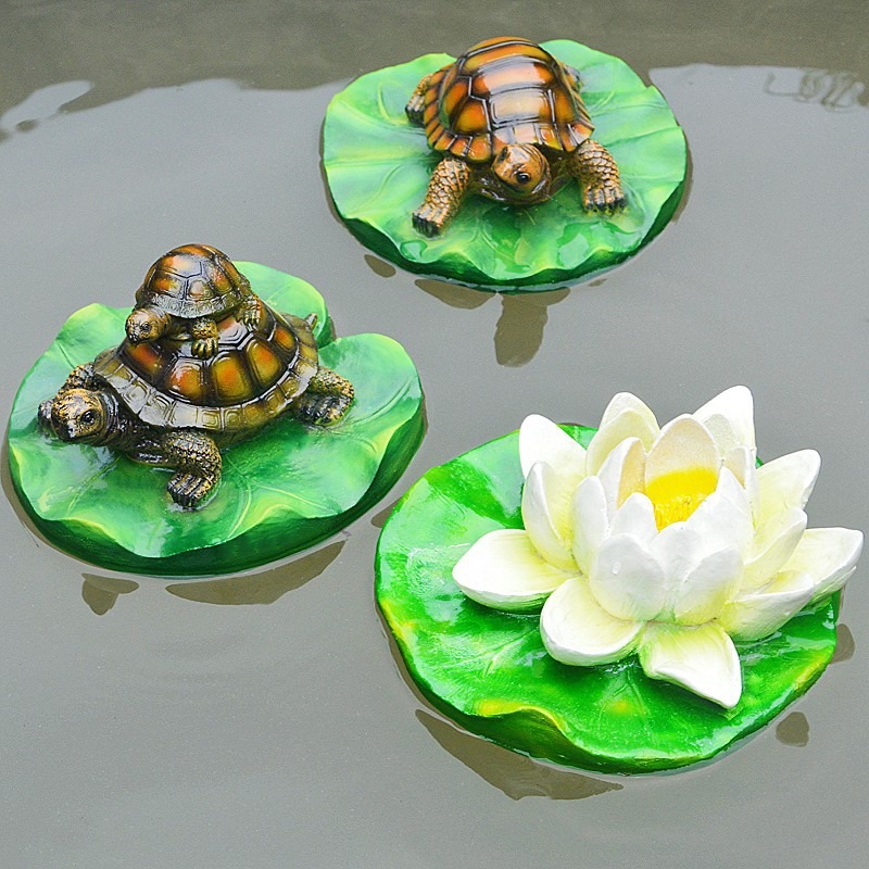 Turtle resin ornaments floating on the water surface — image 6