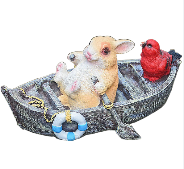 A rowing rabbit resin ornament floating on the water surface — image 2